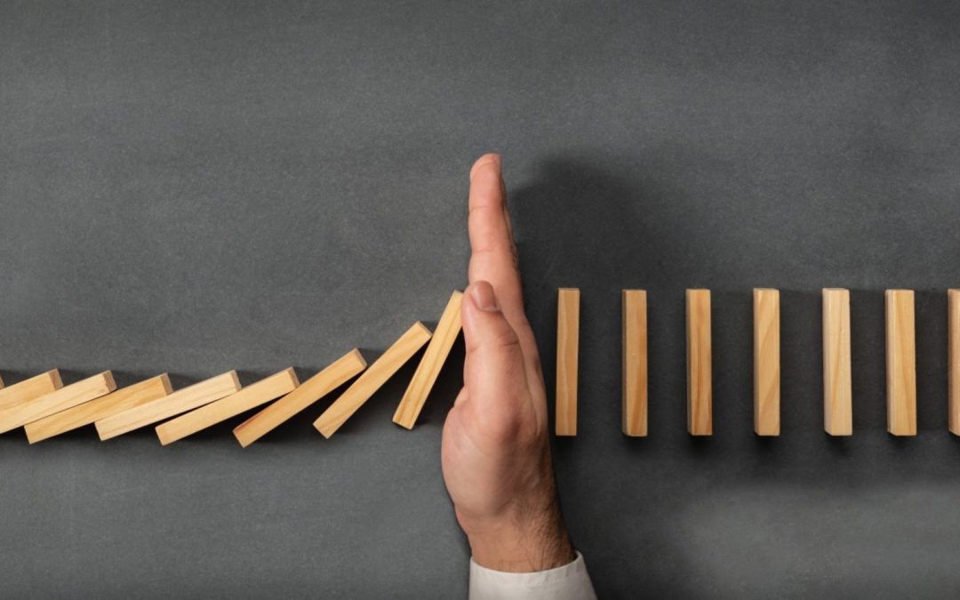 Wooden blocks going sideways falling on a hand that makes them stop.